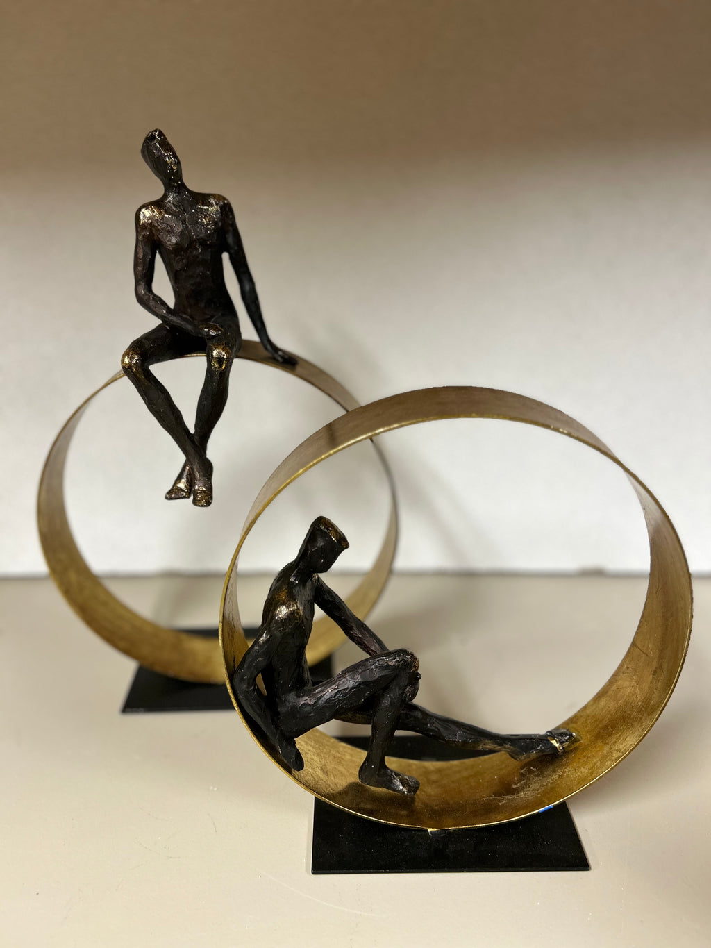 Men Sitting on Gold Structure