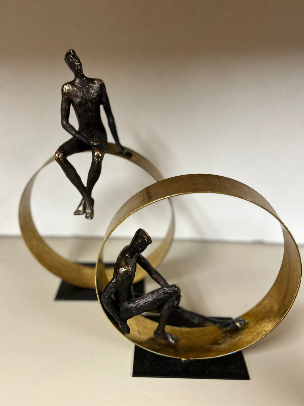 Men Sitting on Gold Structure